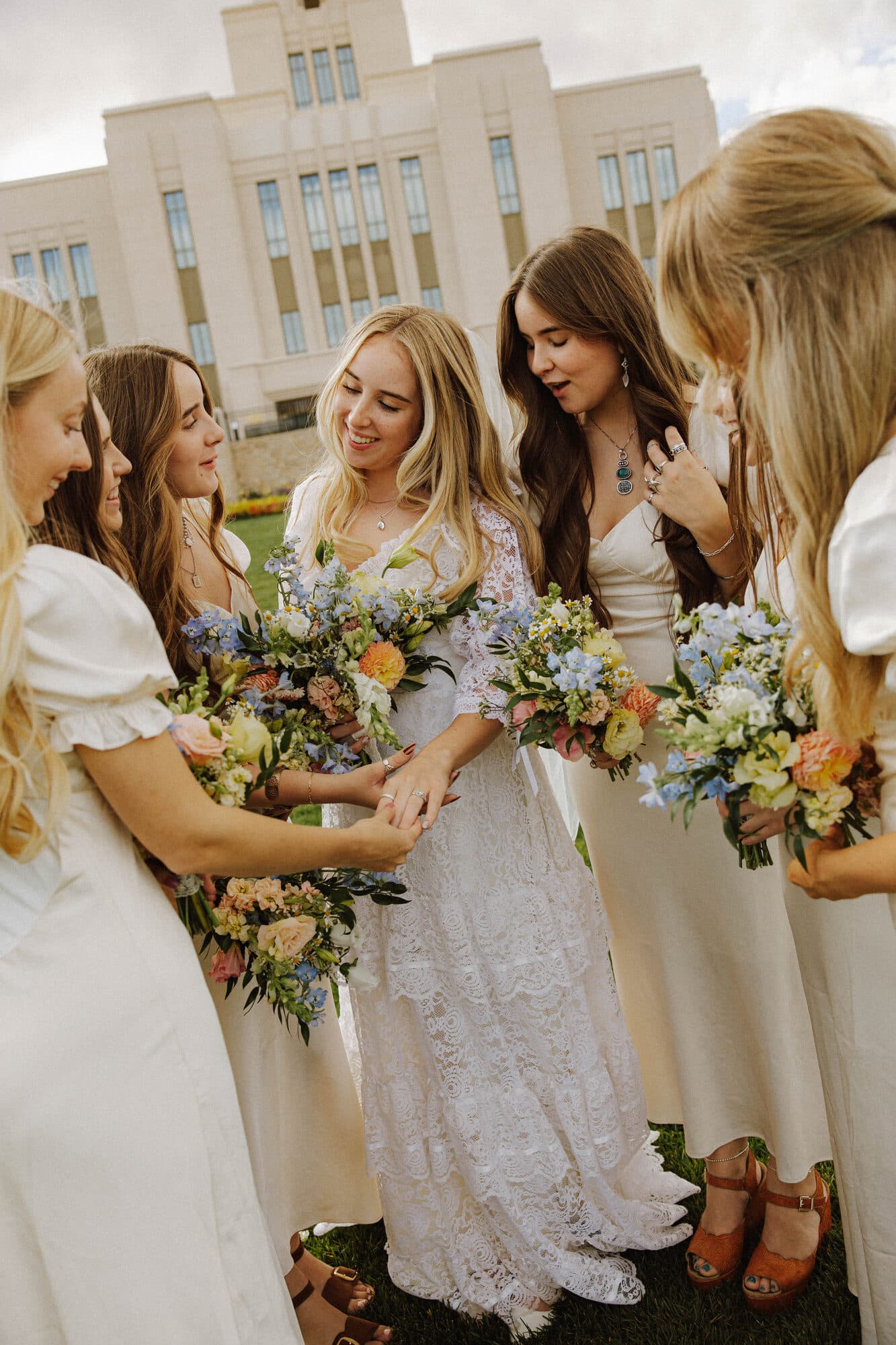 Bride laughing with her bridesmaids before the ceremony